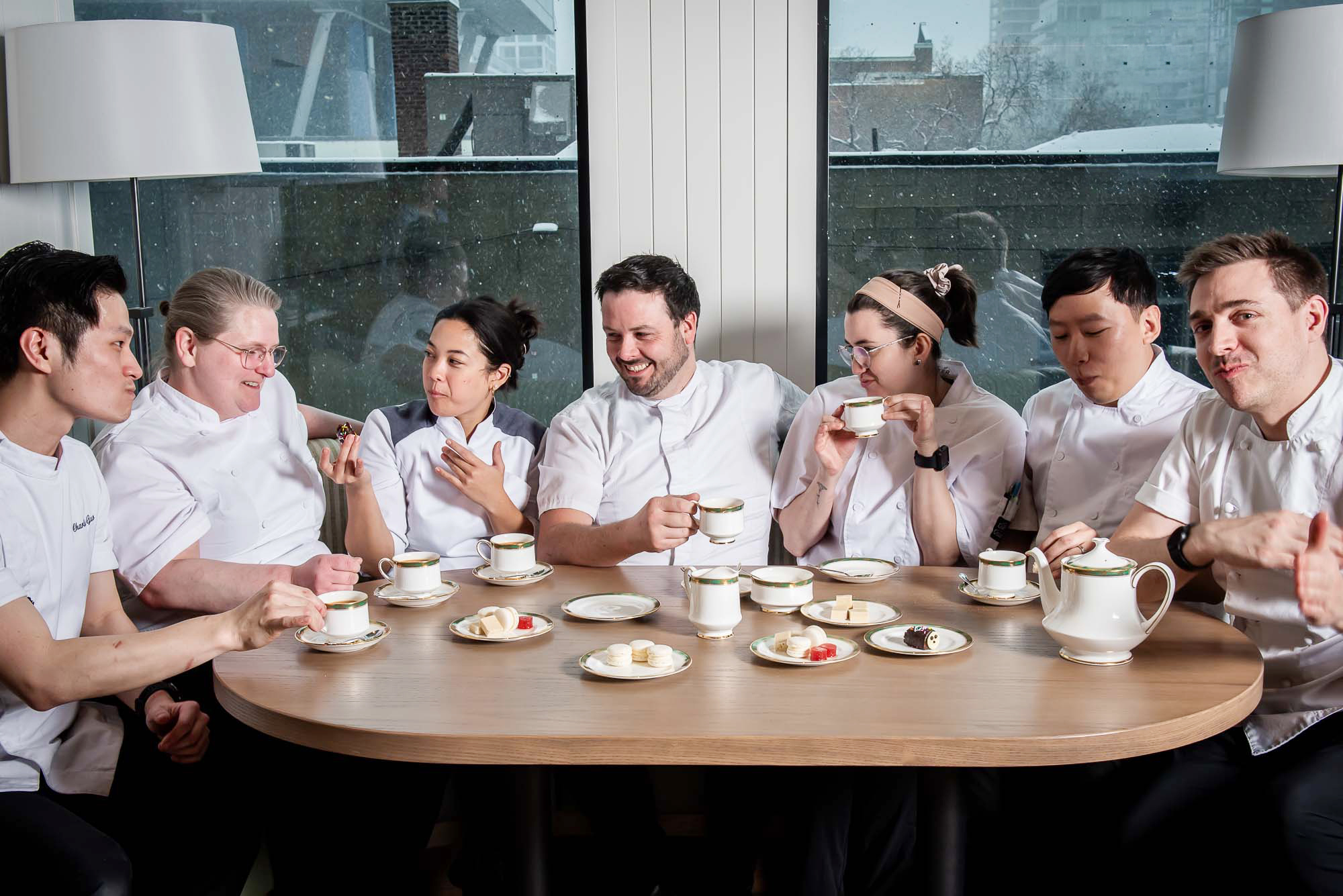 The Dorset back of house team sitting around a table enjoying tea and sweets