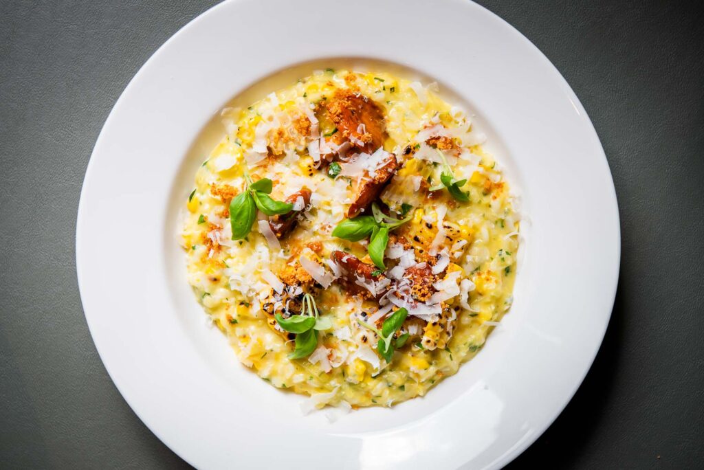 Sweet corn risotto in a white bowl